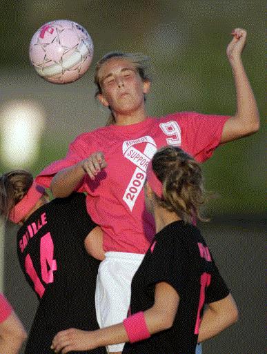Cedar Rapids Kennedy's Jade Grimm heads the ball in a 6-1 girls' soccer win over Linn-Mar on Thursday. (Photo by Jim Slosiarek)